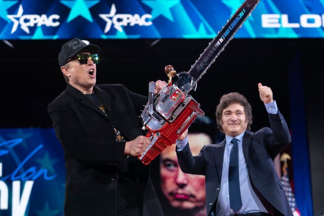 Elon Musk receives a chainsaw from Argentina’s President Javier Milei (Jose Luis Magana/AP)