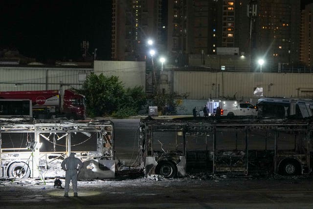 Israeli police inspect the scene of one of a series of bus explosions in Israel 