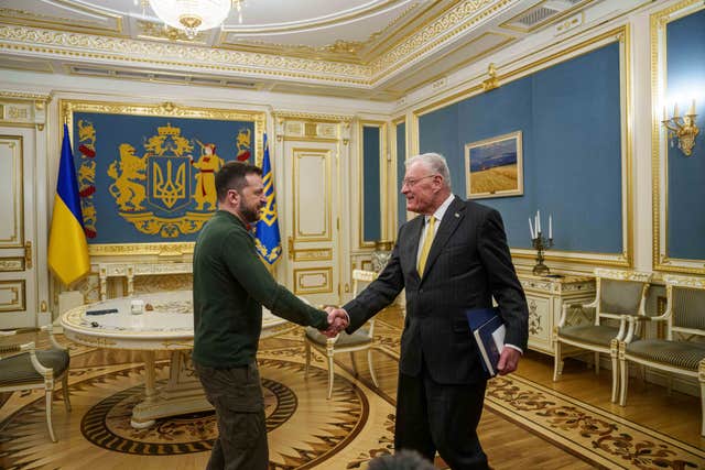 Volodymyr Zelensky and US envoy Keith Kellogg shake hands