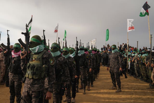 Hamas fighters deploy ahead of handing over four bodies to the Red Cross in Khan Younis,