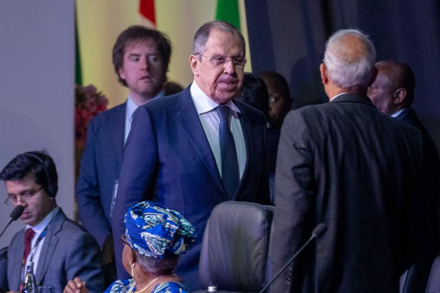 Russian foreign minister Sergey Lavrov, centre, arrives at the opening session of the G20 foreign ministers meeting in Johannesburg, South Africa 