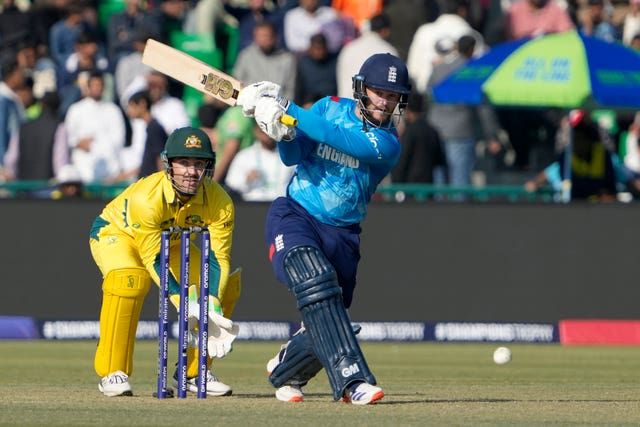 England’s Ben Duckett, right, hits down the ground as Australia wicketkeeper Josh Inglis watches