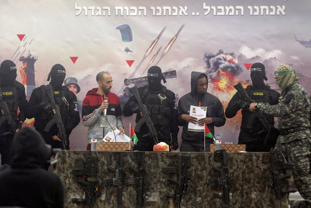 Israeli hostages Tal Shoham, left, and Avera Mengisto surrounded by Hamas fighters 