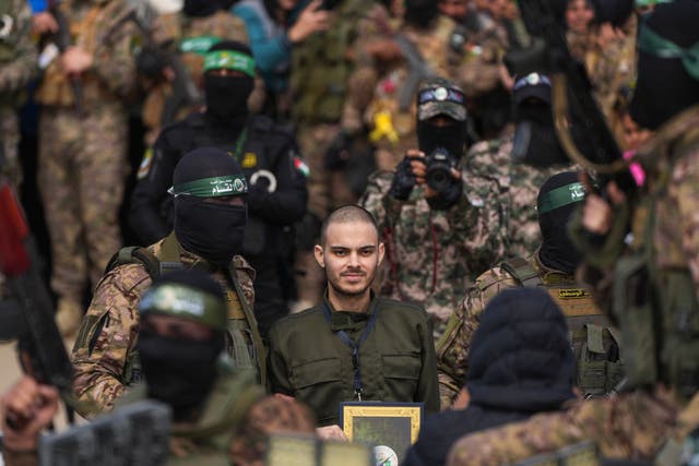 Israeli hostage Omer Wenkert, centre, being escorted by Hamas fighters