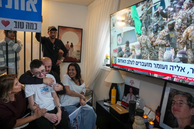 Relatives and friends of Eliya Cohen watching a TV broadcast of his release