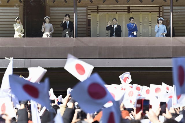 Well-wishers wave to the royal family in Tokyo