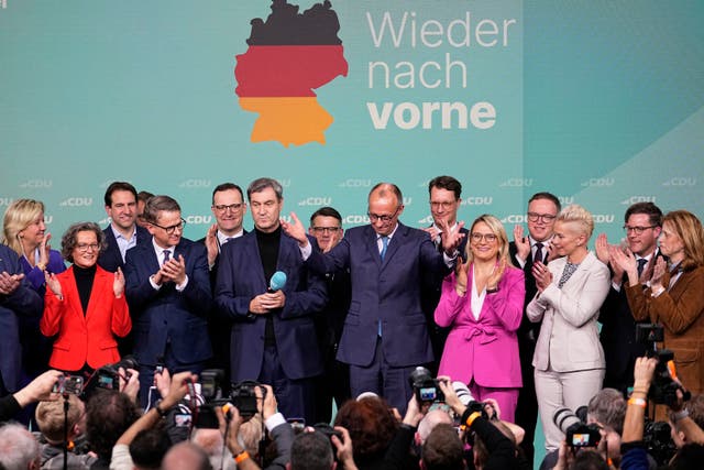 Friedrich Merz gestures to supporters at party headquarters in Berlin