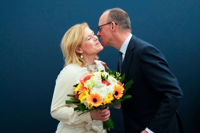 Friedrich Merz, right, receives flowers from Julia Kloeckner, the CDU's treasurer