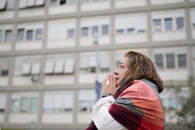 A woman prays outside the hospital in Rome where Pope Francis is being treated