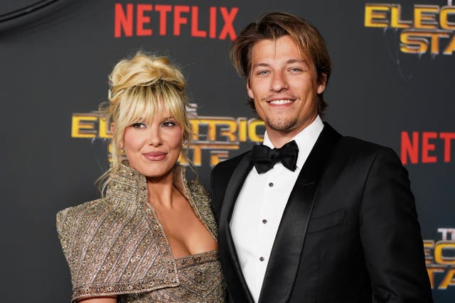 Millie Bobby Brown, left, and Jake Bongiovi arrive at the premiere of “The Electric State”