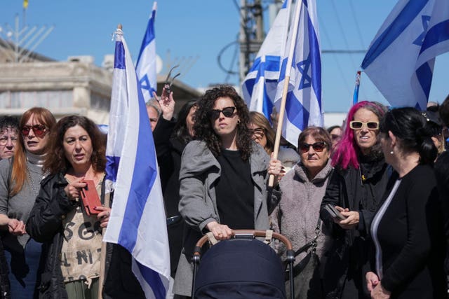 Mourners wave Israeli flags