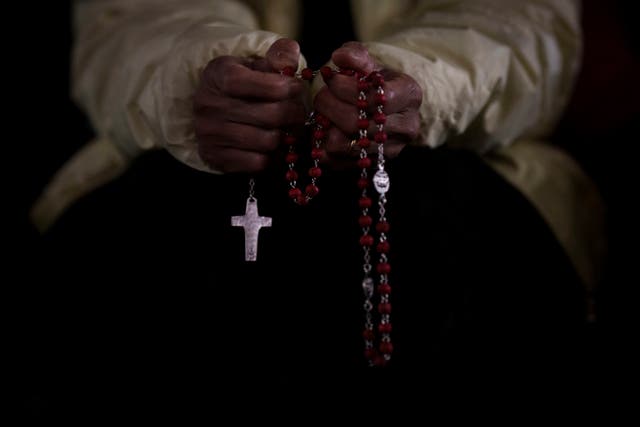 A woman holding a rosary