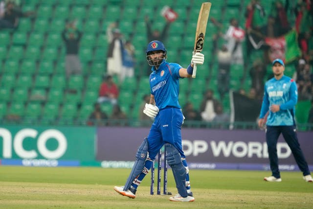 Ibrahim Zadran holds his bat up