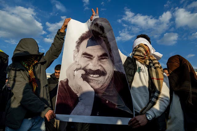 Kurds hold a photograph of jailed leader Abdullah Ocalan