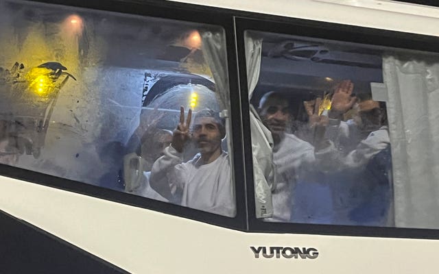 Palestinian prisoners wave from a bus after being released from an Israeli prison 