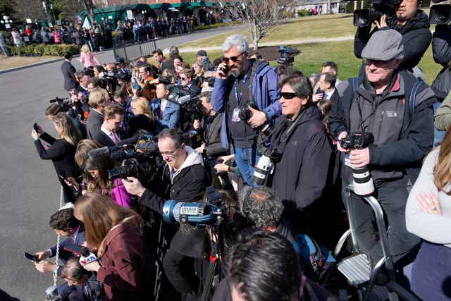 Reporters wait for Ukraine’s president Volodymyr Zelensky to leave the White House