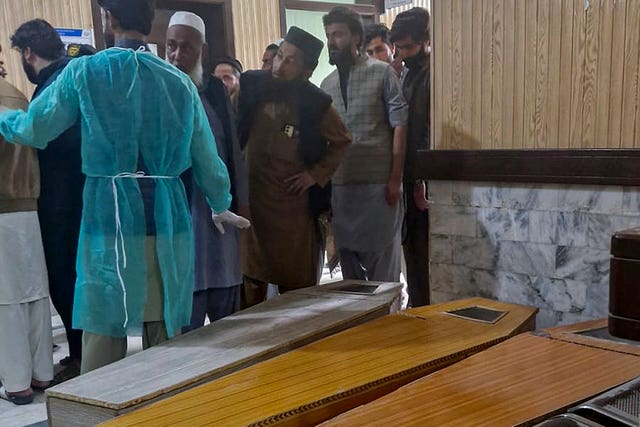 People view coffins following the blast