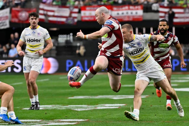 Wigan Warriors Liam Marshall kicks at the ball against Warrington Wolves