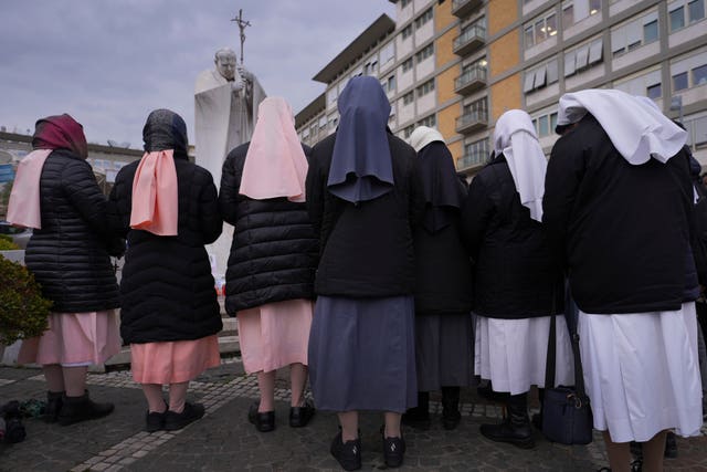 The back of a group of nuns praying