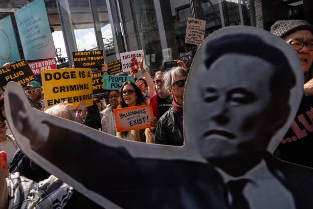 Demonstrators take part in a protest against Elon Musk and Tesla outside a Tesla showroom in New York