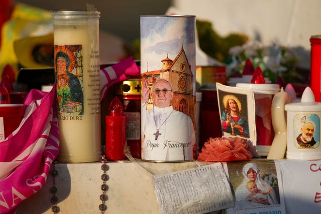 Candles and flowers for Pope Francis outside a hospital in Rome