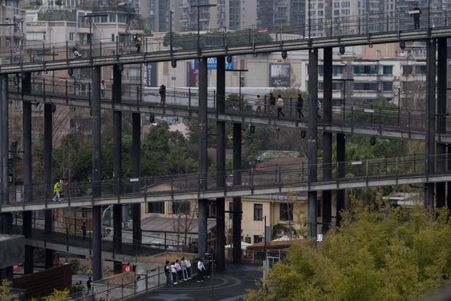 Visitors walk on the walk way at the West Village project by Pritzker Architecture Prize winner Chinese architect Liu Jiakun in Chengdu in southwestern China’s Sichuan province