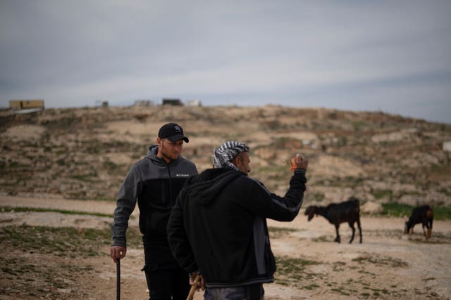 Salem Adra, left, brother of Palestinian activist Basel Adra, who won best documentary feature at the Oscars for No Other Land talks with a local Palestinian shepherd as they stand near an Israeli settlers’ outpost at the West Bank village of Tuwani