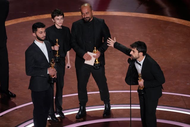 From left, Basel Adra, Rachel Szor, Hamdan Ballal and Yuval Abraham accept the award for best documentary feature film for No Other Land during the Oscars in March at the Dolby Theatre in Los Angeles 