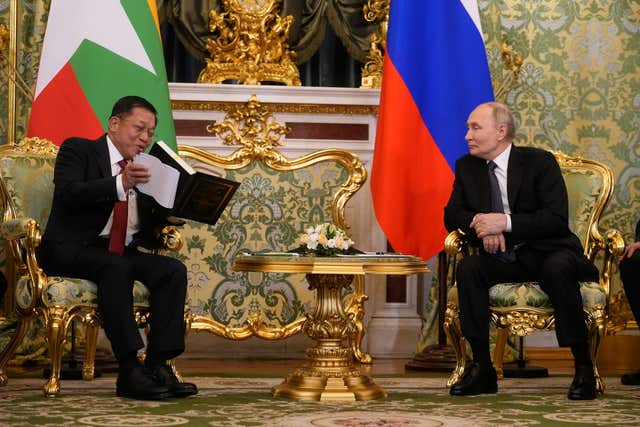 Myanmar’s military leader Gen Min Aung Hlaing presents Russian President Vladimir Putin with a Buddhist book