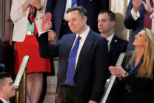 Elon Musk gestures as President Donald Trump addresses a joint session of Congress