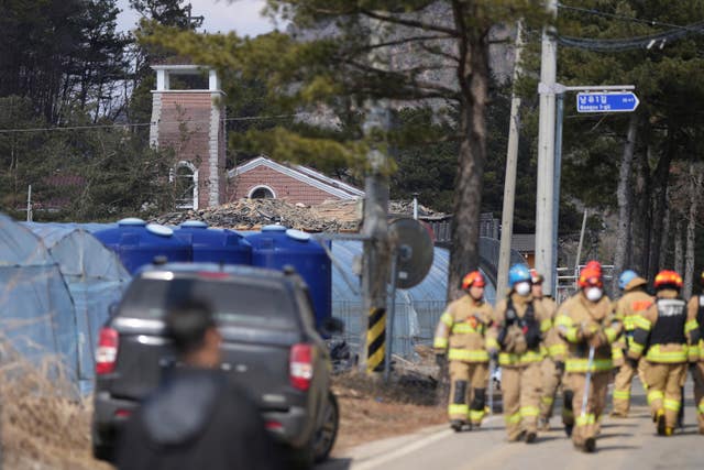 Firefighters survey the damage