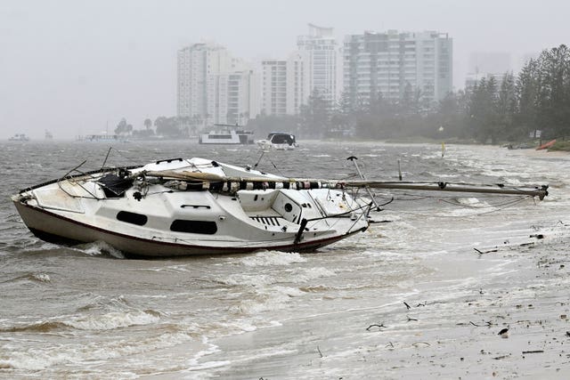 A yacht sits washed ashore in the Broadwater at Labrador following cyclone Alfred on the Gold Coast