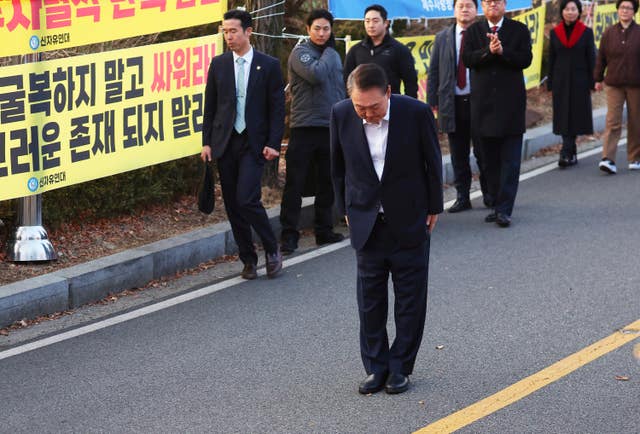 Impeached South Korean President Yoon Suk Yeol  bows to his supporters 