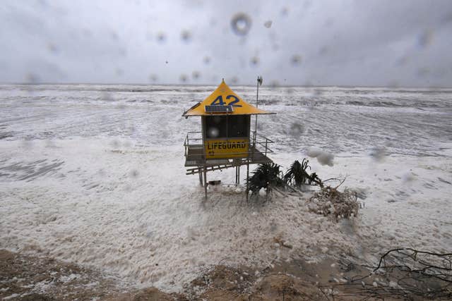 A lifeguard tower is surrounded by heavy seas 