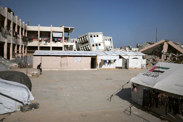 A makeshift classroom is set up within a school compound that is also serving as a shelter for displaced people in Gaza City