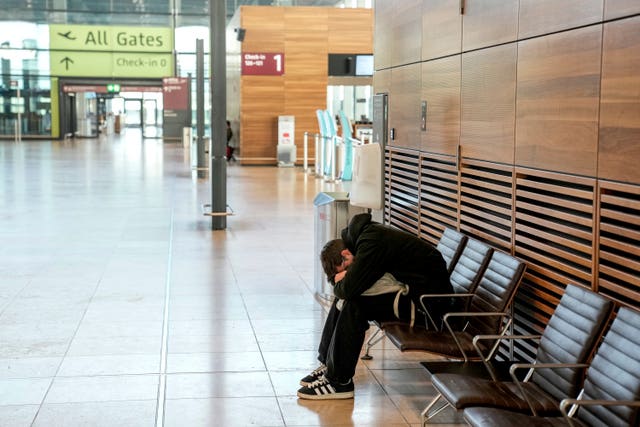 A passenger rests at the Berlin-Brandenburg airport 