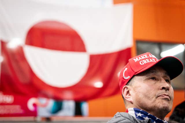 Lars Joergen Kleist in Godthaabshallen wearing a MAGA hat, waits in line to cast his vote in the parliamentary elections to Inatsisartut in Nuuk 