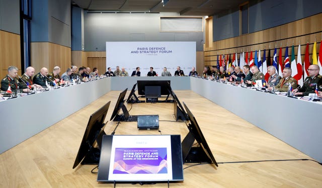 Participants in a defence meeting in Paris sitting at a large U-shaped table