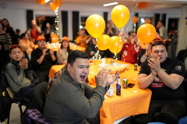 Members of the Naleraq party applaud during a party after parliamentary elections in Nuuk, Greenland