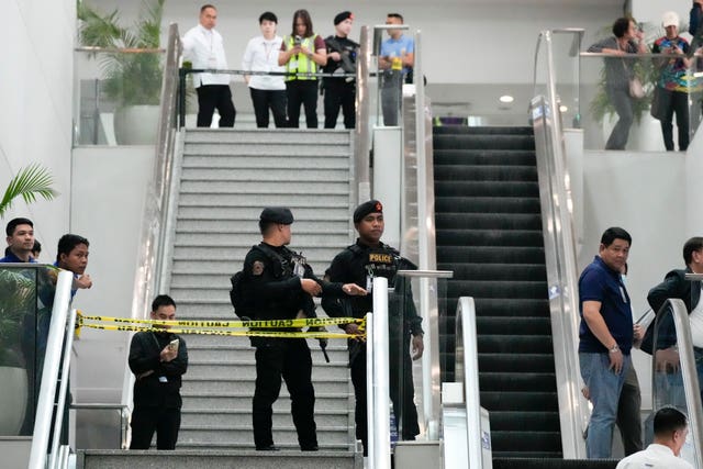 Armed police secure an area following the arrest of former Philippine president Rodrigo Duterte at the airport in Manila Duterte’s Chaotic Arrest