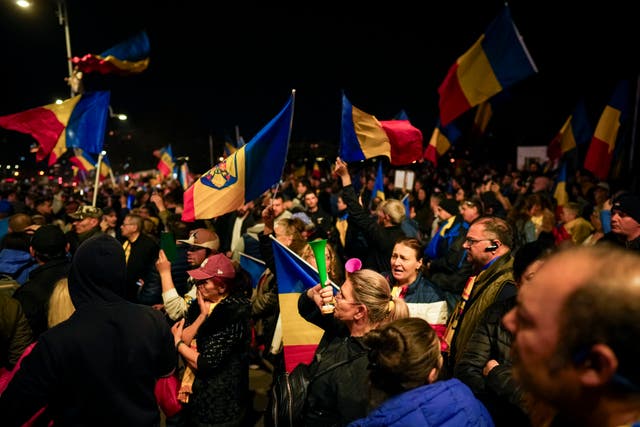 Supporters of Calin Georgescu react during a protest