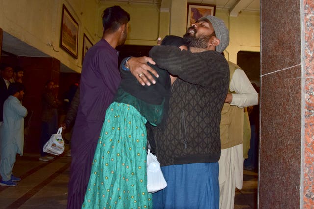 A man hugs one of the rescued passengers