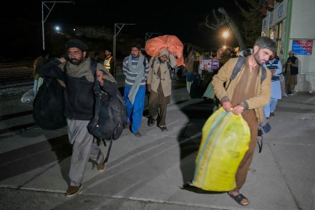 Rescued passengers arrive arrive at Much railway station in Balochistan province 