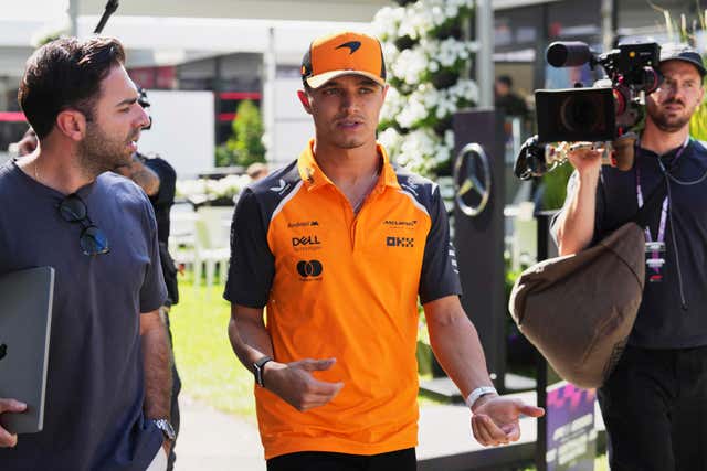 McLaren driver Lando Norris walks in the F1 paddock in Melbourne