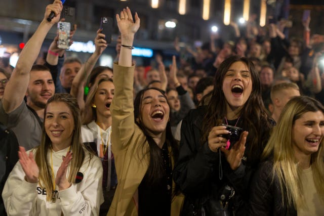 Young women wave their arms in the air