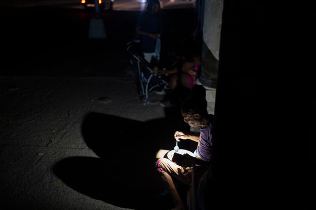 People eat by torchlight