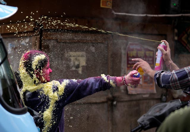 Indians spray colours on each other as they celebrate Holi in Jammu