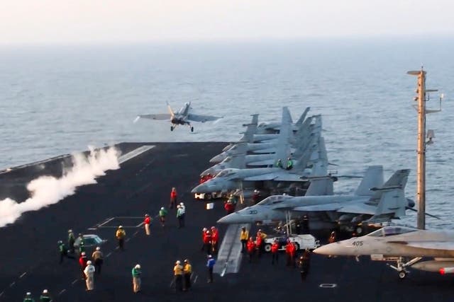 This image taken from video provided by the U.S. Navy shows an aircraft launching from the USS Harry S Truman in the Red Sea before airstrikes