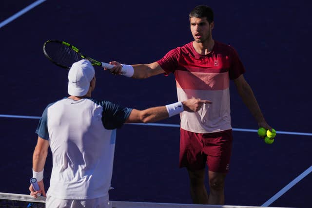 Carlos Alcaraz discusses a point with Jack Draper