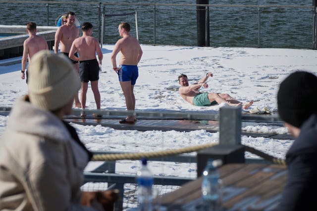 People enjoy a sunny and frosty day after sweating in the sauna of the public bath in Helsinki, Finland